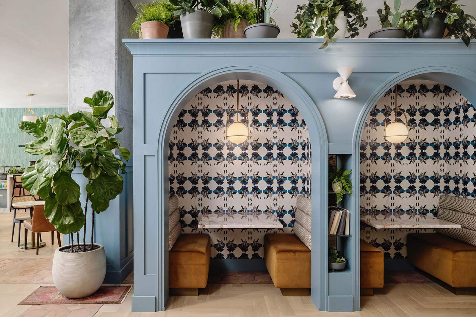 Patterned wallpaper framing built-in seating alcoves